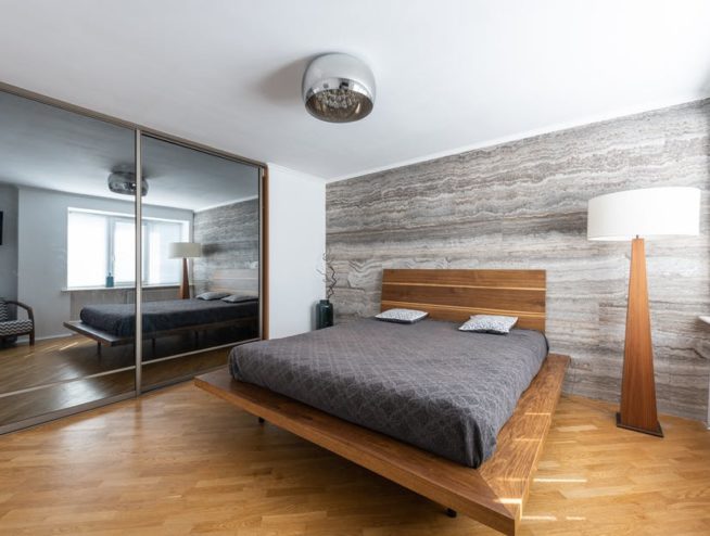 picture of a bedroom with a mirror wall