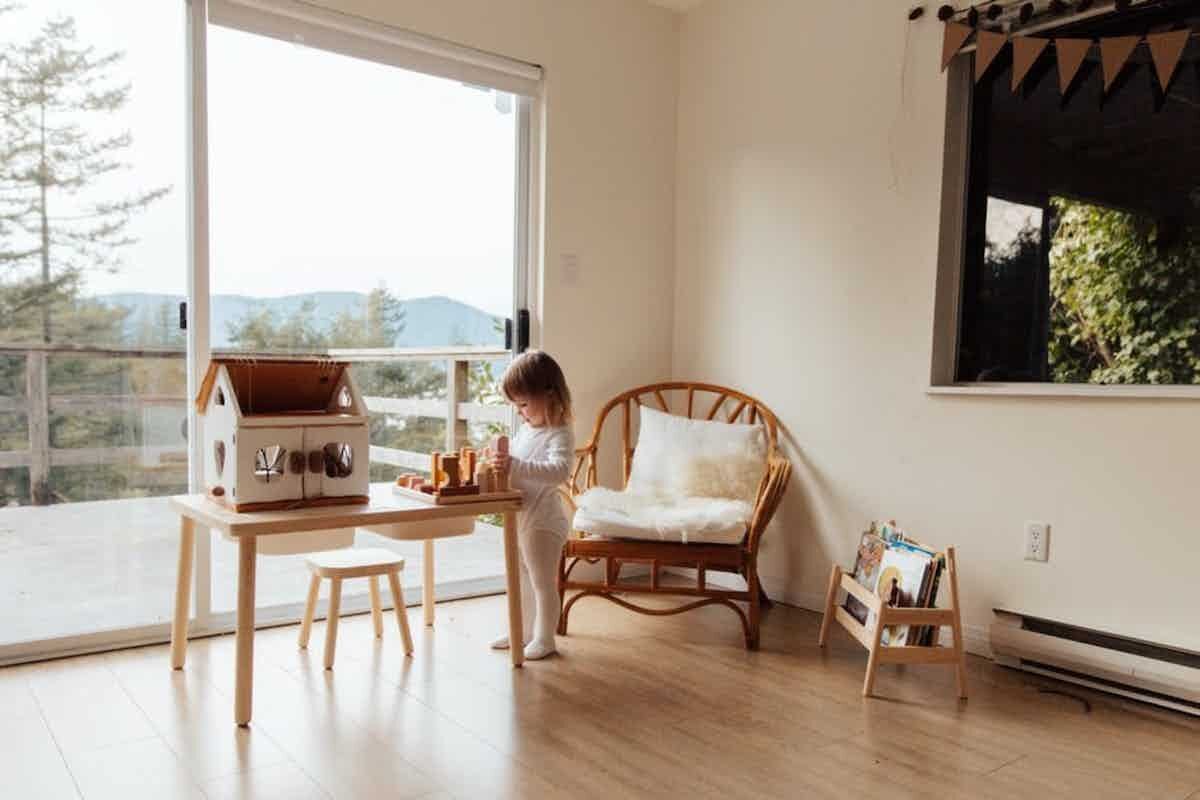 Kid playing in a house with sliding glass doors